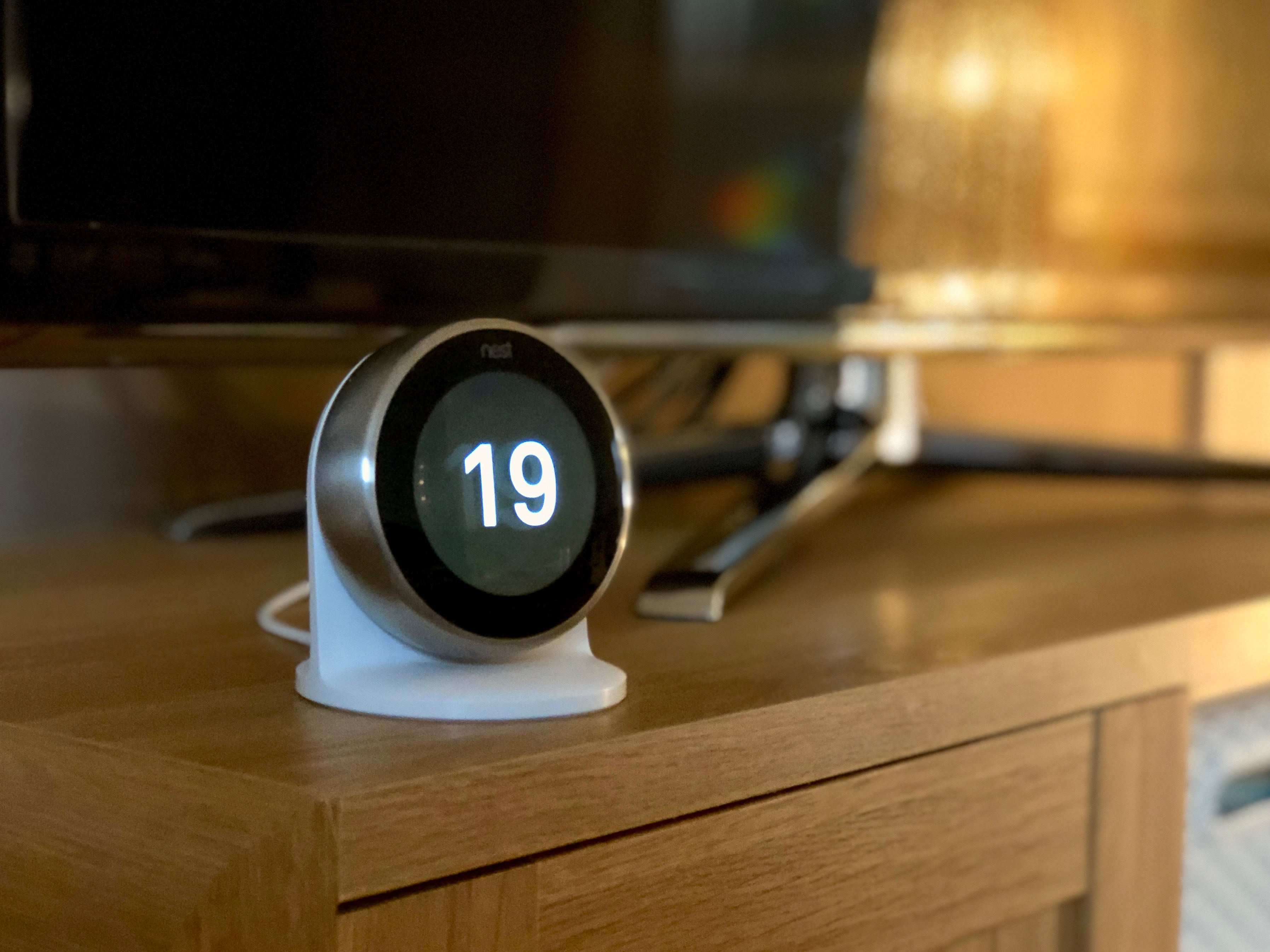 Nest smart thermostat on its stand