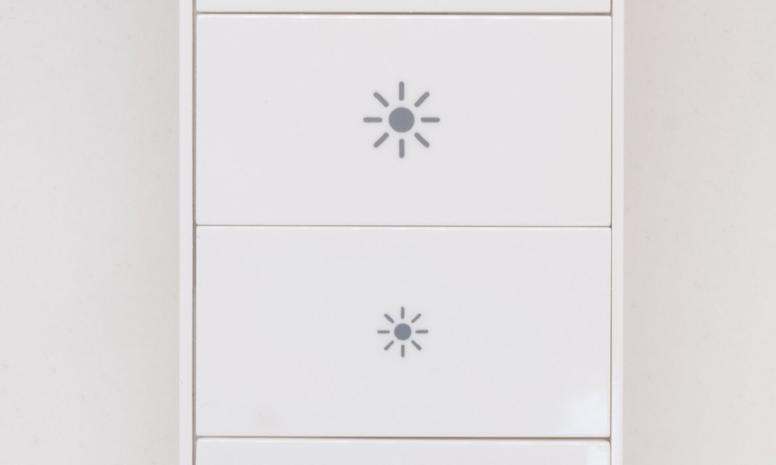 Philips Hue wireless dimmer switch beside smart bulbs