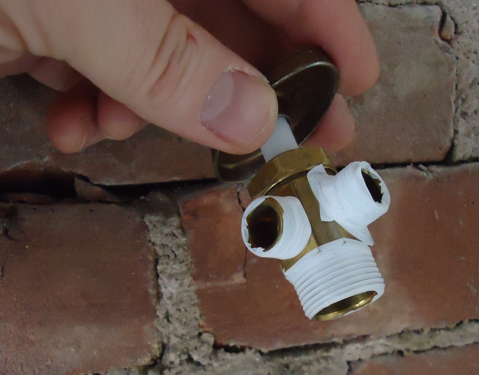 An isolation valve on new plumbing beneath a kitchen sink
