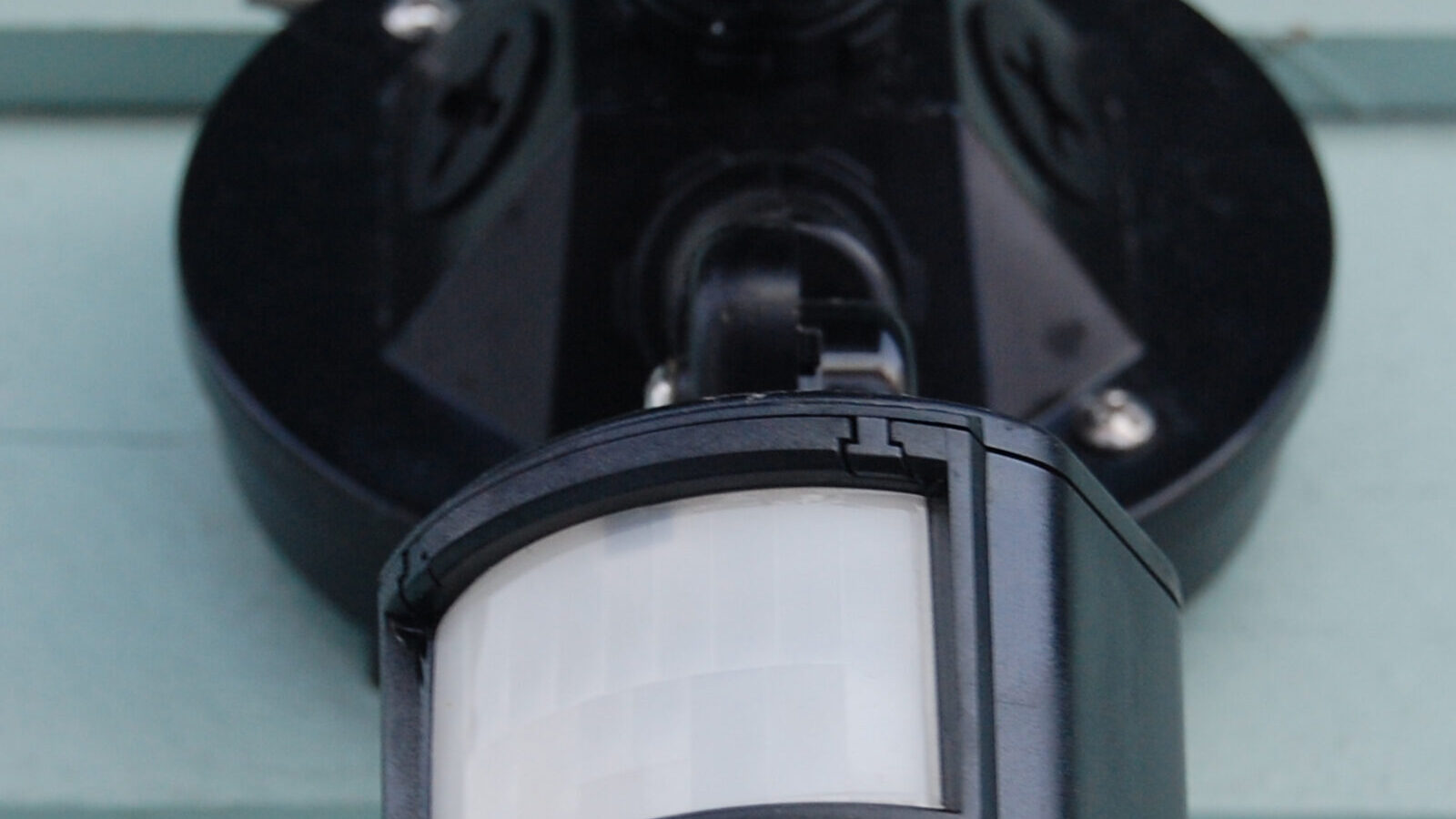 Passive infrared motion detector mounted on a wall