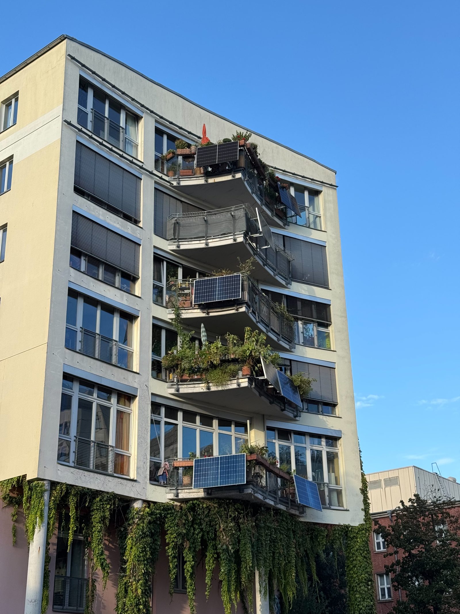 Several apartment balconies with solar panels fixed to the railings