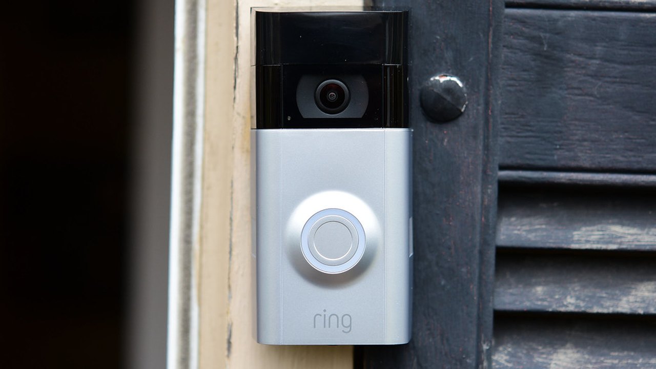 Outdoor home security camera mounted under a roofline