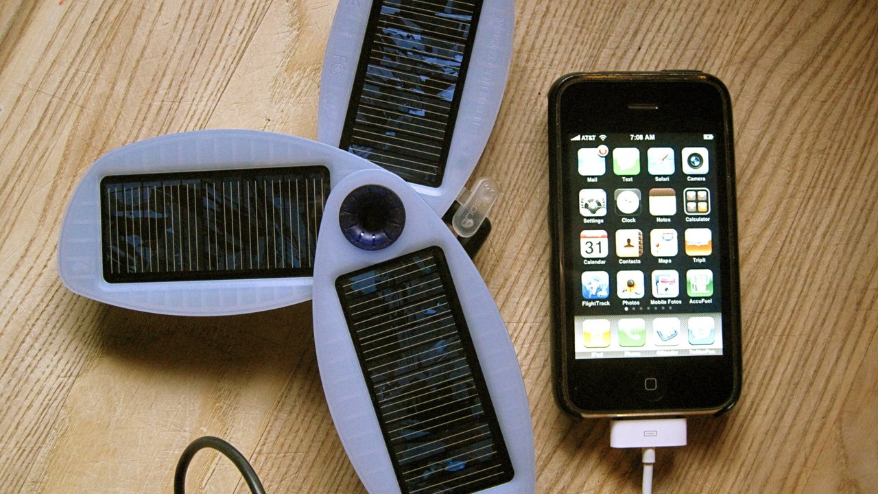 Folding solar panel charging a device outdoors