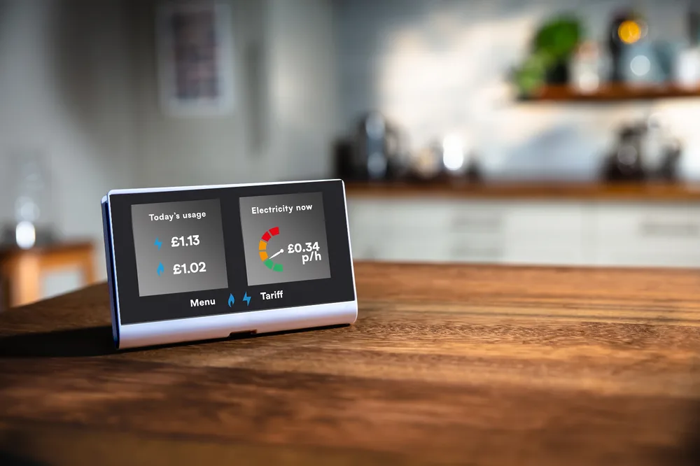 UK smart meter in-home display (IHD) on a kitchen counter showing today's usage and live electricity price